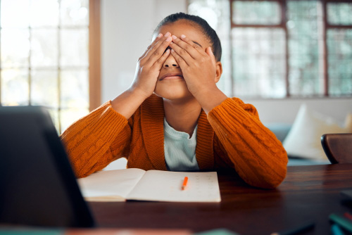 Child covering eyes may have anxiety and need cold therapy for anxiety relief