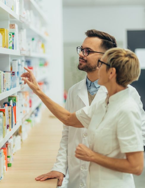 Happy young male pharmacist working with senior co 2023 11 27 05 19 07 utc e1717435187807